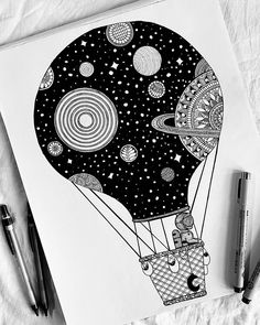 a black and white drawing of a hot air balloon with planets in the sky above it