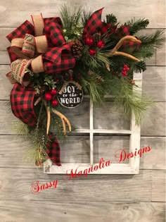 a christmas wreath hanging on the side of a window