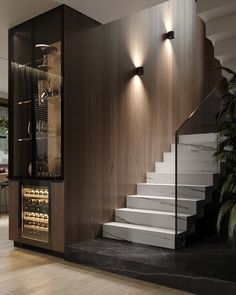 the stairs are built into the wall next to the wine rack in this modern home