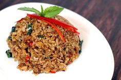 a close up of a plate of food with rice and vegetables on it's side