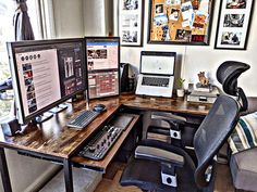 two computer monitors sitting on top of a wooden desk