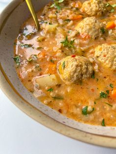 a bowl of soup with meatballs and vegetables