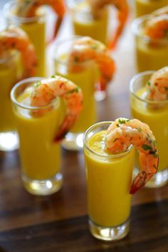 several glasses filled with drinks and garnished with shrimp