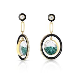 The Halo Enamel Shaker Earrings in 18 karat gold and black enamel feature a 16mm white sapphire Kaleidoscope Shaker™ filled with baguette shaped emeralds. The enamel hoop surrounding the Shaker™ creates movement in addition to emeralds within the Shaker™. To preserve this piece, consult the care instructions. DescriptionEarrings with 1.88ct of diamonds and 2.56ct of emeralds set in and enclosed in white sapphire Kaleidoscope shakers in 18k gold and black enamel. Materials and Measurements• 1.88ct of Diamonds• 2.56ct of emeralds• 18k Gold• Handmade Enameling• Shaker Size: 16 mm• Overall Size: 50 x 27 mm Details• Made in New York City• Style # E992 New York City Style, Jewelry Illustration, Halo Earrings, Fun Jewelry, Emerald Earrings, Enamel Earrings, Precious Gems, City Style, Creative Arts