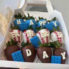 some chocolate covered strawberries in a box with happy birthday written on them and decorated to look like baseballs