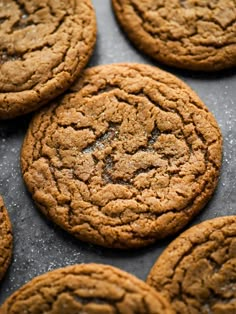 several cookies on a baking sheet ready to be baked in the oven, with one cookie missing