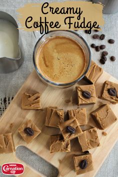 a wooden cutting board topped with fudge next to a cup of coffee and spoon