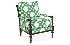 a green and white chair with an intricate pattern on the armrests, sitting in front of a white background