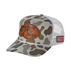 Step up your outdoor style with the Bass Pro Shops Faux-Leather Patch Camo Mesh-Back Cap. This stylish Bass Pro cap sports a sleek faux-leather leaping-bass logo patch front and center. The rope accent above the bill gives throwback vibes. An American flag patch on the side adds a patriotic note. The mesh back promotes cooling airflow, and a snapback closure allows a personalized fit.      Faux-leather BPS patch front and center;      Rope accent;      Mesh back for built-in cooling;      Americ Womens Hunting Gear Bass Pro Shops, Casual Leather Trucker Hat For Outdoor, Casual Leather Trucker Hat, Casual Leather Hat For Streetwear, Leather Baseball Cap With Flat Bill For Outdoor, Leather Flat Bill Baseball Cap For Outdoor, Casual Leather Snapback Hat For Outdoor, Casual Leather Trucker Hat With Flat Bill, Bass Logo