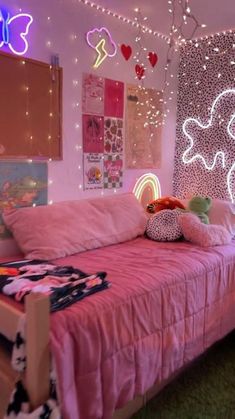 a bedroom decorated in pink and white with lights