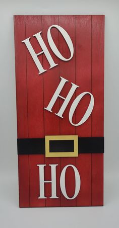 a wooden sign with the words ho ho written in white letters on red planks