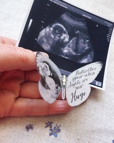 a hand holding a butterfly shaped brooch with an x - ray in the background