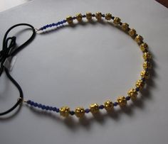 Gold Bali Bead Lapis Blue Stone Elastic Headband, for weddings, parties, evening, special occasions Elegant Blue Headband As Gift, Adjustable Gold Headband For Festive Occasions, Adjustable Beaded Headband For Party, Traditional Blue Beads With Natural Stones, Elegant Blue Headband Gift, Elegant Blue Headband For Gift, Adjustable Blue Headband For Parties, Navy Blue Hair Beads, Gold Bali