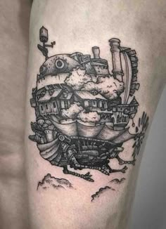 a man's thigh with a black and white drawing of a ship on it