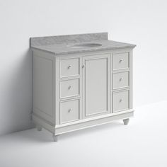 a white bathroom vanity with marble top and drawers on the bottom, in front of a wall