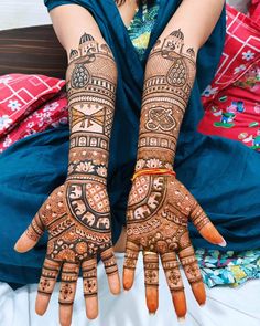 a woman's hands with henna tattoos on them