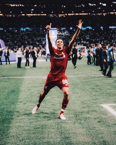 a soccer player is celebrating his team's victory over the crowd at an event