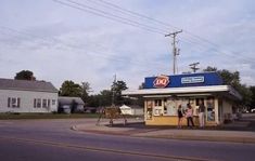 two people are standing in front of a convenience store