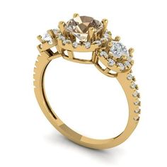 a yellow gold engagement ring with three stones on the side and an oval center stone