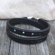 Made from top quality vegetable tanned leather.Hand painted and stamped leather wrap around bracelet. It is embellished with natural Tibetan Turquoise cabochons.Bangle is 1 cm wide and with zamak clasp closure.Please measure carefully your wrist and select the most preferable size!If you need a diferent size, please let me know after purchase in "note for seller".Please visit to my another shop:https://www.etsy.com/shop/JeansBelt?ref=hdr_shop_menu************************************************* Adjustable Black Hand Tooled Bracelet, Rustic Leather Concho Bracelets, Southwestern Hand Tooled Leather Bracelets, Western Leather Bracelet As A Gift, Western Style Hand Tooled Leather Bracelets, Western Style Leather Bracelets As Gifts, Western Style Leather Bracelets For Gift, Western Style Leather Bracelet Gift, Adjustable Southwestern Hand-tooled Bracelets