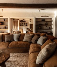 a living room filled with furniture and lots of pillows