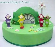 a green cake decorated with three cartoon characters