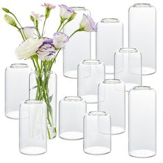 a bunch of vases with flowers in them on a white background, all lined up together