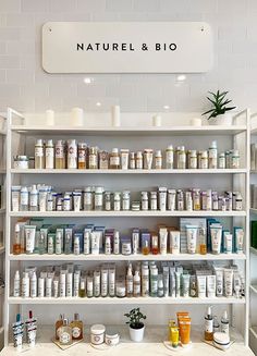 a shelf filled with lots of different types of items next to a sign that says natural & bio