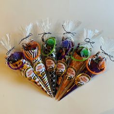 six halloween candy wrapped in cellophane and tied with twine