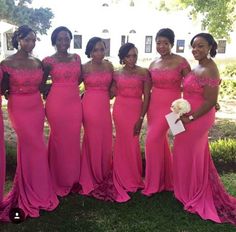 a group of women standing next to each other in pink dresses