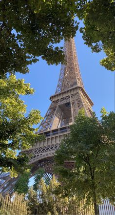 the eiffel tower is seen through some trees