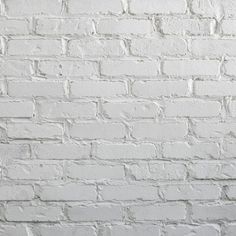 an old white brick wall textured with paint