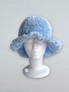 Get ready for the colder months with our chic and bold bucket hat. It's crafted from faux fur fluffy yarn. ⦿ Lightweight and durable ⦿ Fluffy design ⦿ Soft top and brim Fashion bucket hat is made of faux fur plush  yarn. Soft and very comfortable It's lightweight and foldable for easy storage or for taking on the go while traveling This hat is suitable for all seasons Knitted hats are flexible and suitable for most head sizes.  Brim width: approx. 7 cm Height of crown: approx. 12 cm This is a gr Winter Blue Bucket Hat, Trendy Blue Winter Bucket Hat, Trendy Blue Bucket Hat For Winter, Blue Winter Bucket Hat, Crochet Hat Winter, Fashion Bucket Hat, Fluffy Bucket Hat, Fur Bucket Hat, Fluffy Yarn