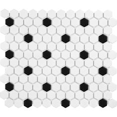 black and white hexagonal tiles are arranged in an irregular pattern on the wall