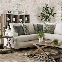 a living room filled with furniture next to a brick wall