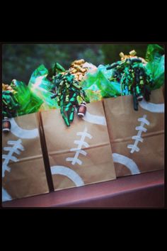 some brown paper bags with football decorations on them