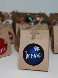 several christmas ornaments are on display in small brown boxes with tags that say trene and snowflakes