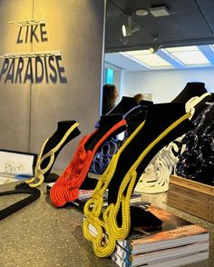 there are many different types of shoes on display at the store, including one with a yellow shoelace