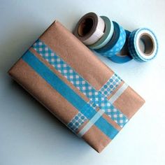 two rolls of tape are wrapped in brown paper