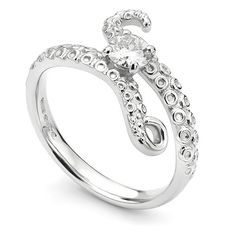 a white gold ring with an octopus design on the front and side, set with diamonds