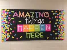 a sign that says amazing things happen here on the side of a wall in a bathroom