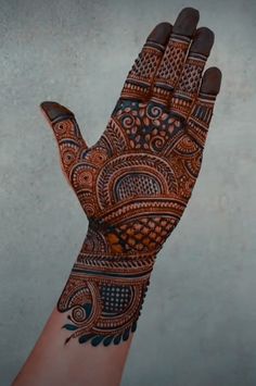 the hand is decorated with intricate designs