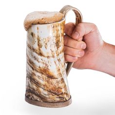 a hand holding a coffee mug that is dirty