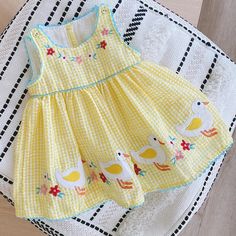 The "Tilly" Dress is a charming addition to any little girl's wardrobe. Made from soft, lemon, cotton, gingham fabric. It features darling appliqued ducks and delicate embroidered flowers around the hemline. The covered buttons and matching bric brac add a stylish touch to this dress. Perfect for Easter and beyond. Your little one will look adorable and feel comfortable in this lovely dress. Material: Cotton Fit: Fits true to size, take your normal size Age Range: 6 Months-6 Years Girls Easter Dresses, Gingham Fabric, Easter Girl, Vestidos Vintage, Easter Dress, Girls Wardrobe, Lovely Dresses, Belle Epoque, Covered Buttons