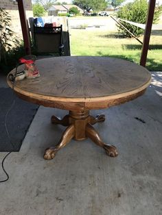 a wooden table sitting on top of a cement floor