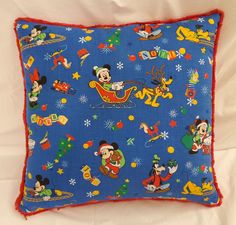 a mickey mouse christmas pillow on a bed