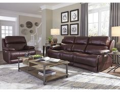 a living room with two recliners and a coffee table in front of the couch