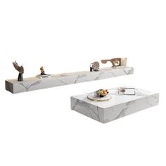 two white marble coffee tables with figurines on each side and one sitting at the end