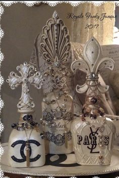 an assortment of chandeliers and perfume bottles on a table