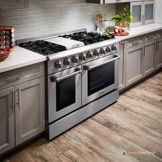 a stove top oven sitting inside of a kitchen next to a counter with fruit on it